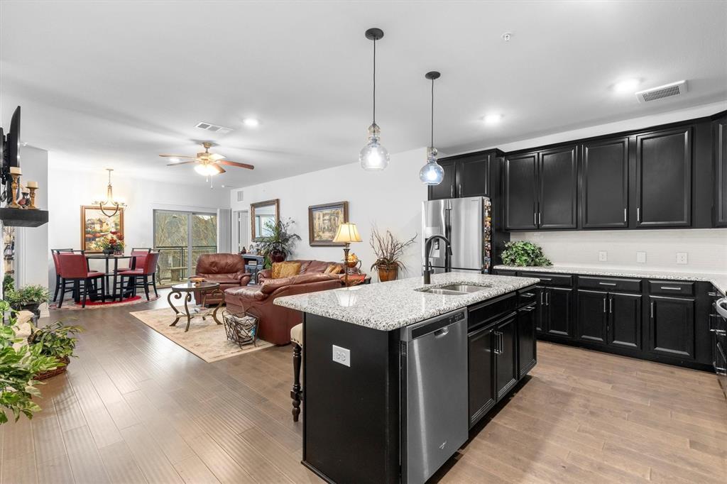 a kitchen with lots of counter space a sink appliances and cabinets
