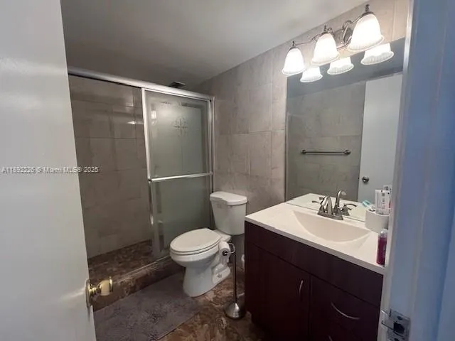 a bathroom with a sink toilet and a mirror