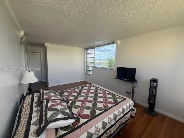 a bedroom with a bed and a desk