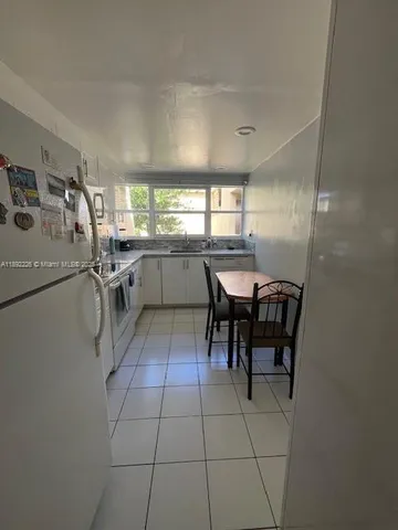 a kitchen with a sink a counter top space and appliances