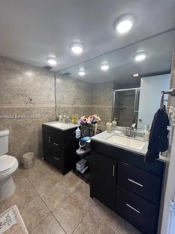 a bathroom with a sink double vanity and a mirror