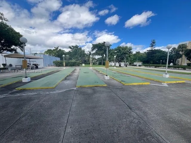 a view of outdoor space with playground and green space