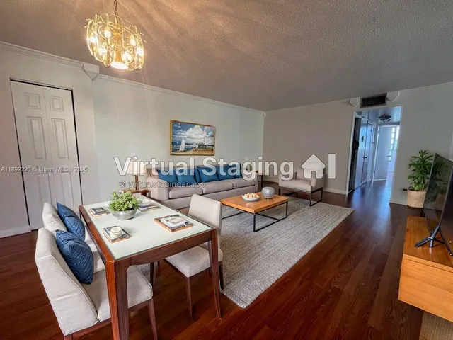 a living room with furniture dining table and wooden floor
