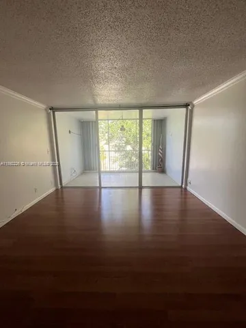 a view of wooden floor and windows in a room