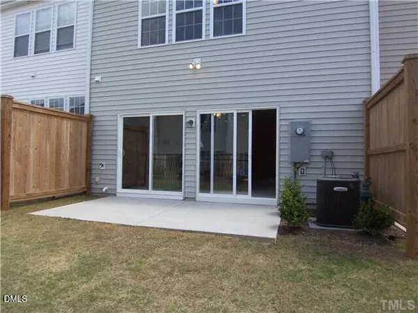 a view of a brick house with a large window and yard