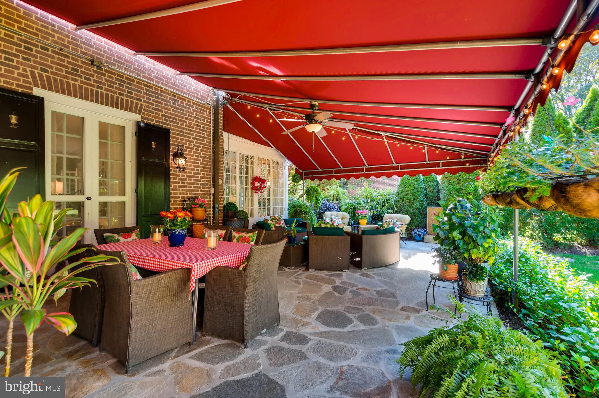 5302 Springlake Way Baltimore, MD 21212 - Photo 22 of 35 a view of a patio with a table and chairs under an umbrella