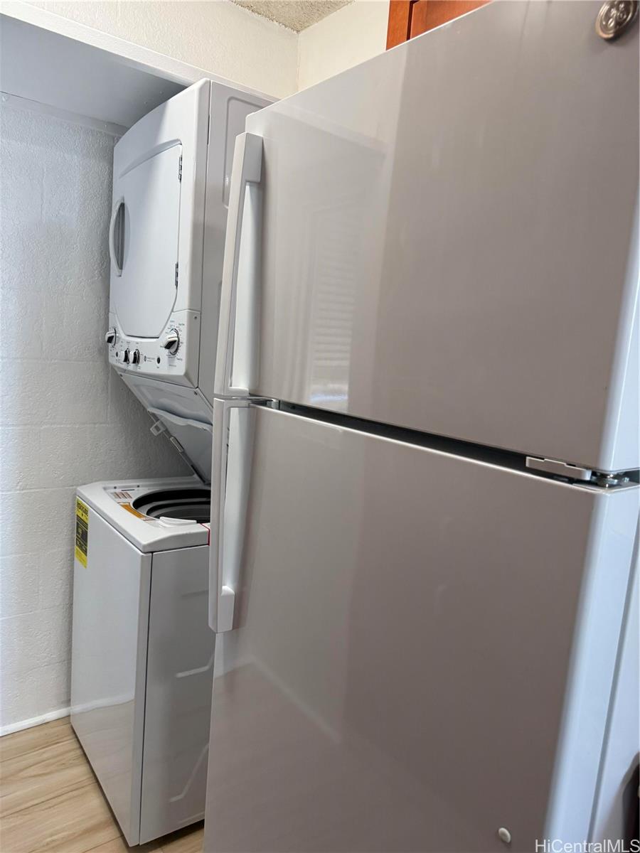 1226 Alexander Street, Unit 505 Honolulu, HI 96826 - Photo 11 of 24 a white refrigerator freezer and a stove sitting inside of a kitchen