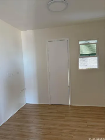 a view of a room with wooden floor and a sink