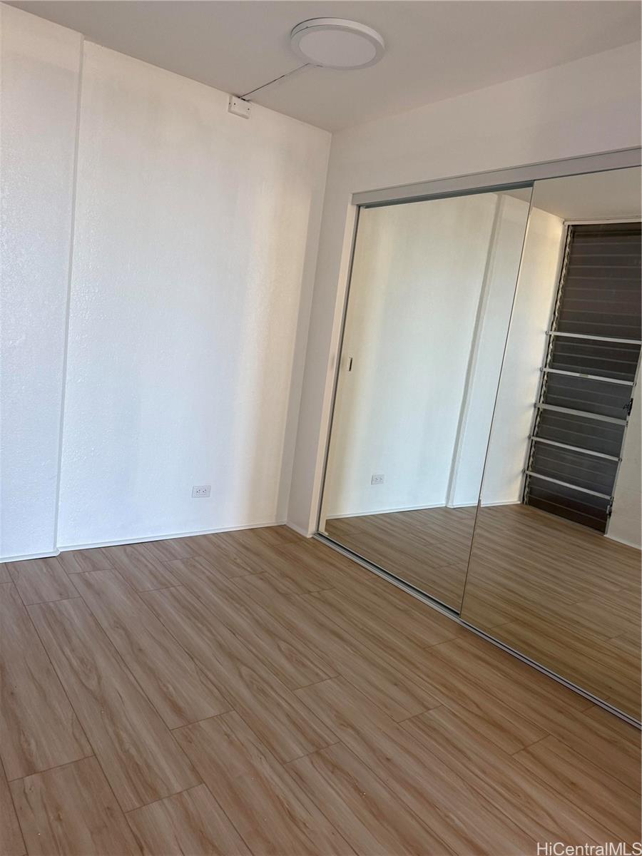 1226 Alexander Street, Unit 505 Honolulu, HI 96826 - Photo 2 of 24 a view of an empty room with wooden floor and stairs