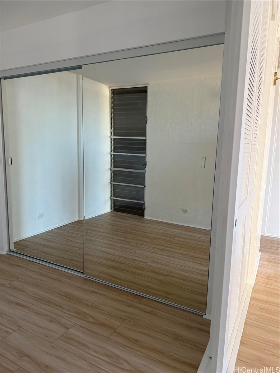 1226 Alexander Street, Unit 505 Honolulu, HI 96826 - Photo 3 of 24 a view of empty room with wooden floor and fan