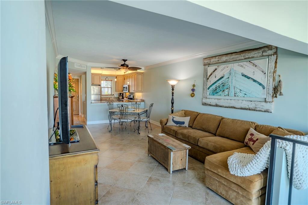 803 River Point Drive, Unit 105B Naples, FL 34102 - Photo 11 of 36 a living room with furniture and a table