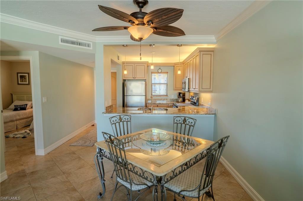 803 River Point Drive, Unit 105B Naples, FL 34102 - Photo 15 of 36 a dining room with furniture and window