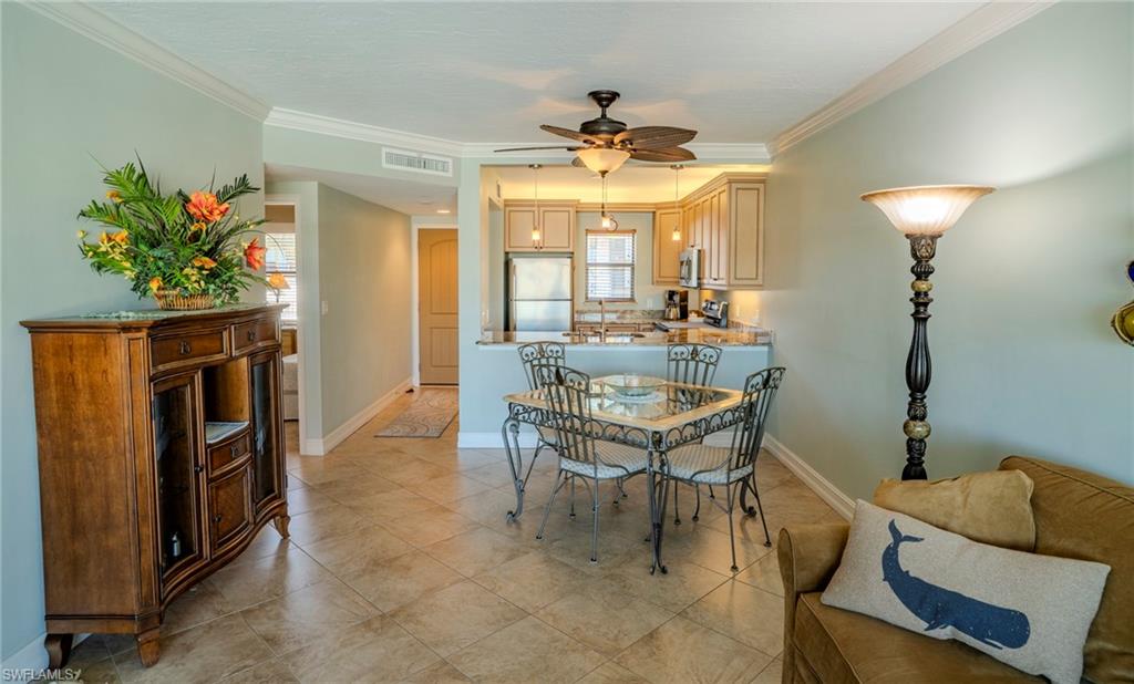 803 River Point Drive, Unit 105B Naples, FL 34102 - Photo 18 of 36 a dining room with furniture and chandelier