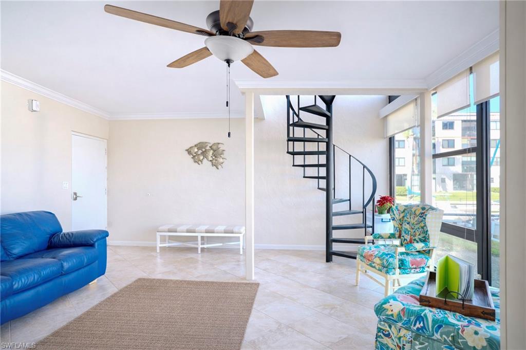 803 River Point Drive, Unit 105B Naples, FL 34102 - Photo 2 of 36 a living room with furniture and a potted plant