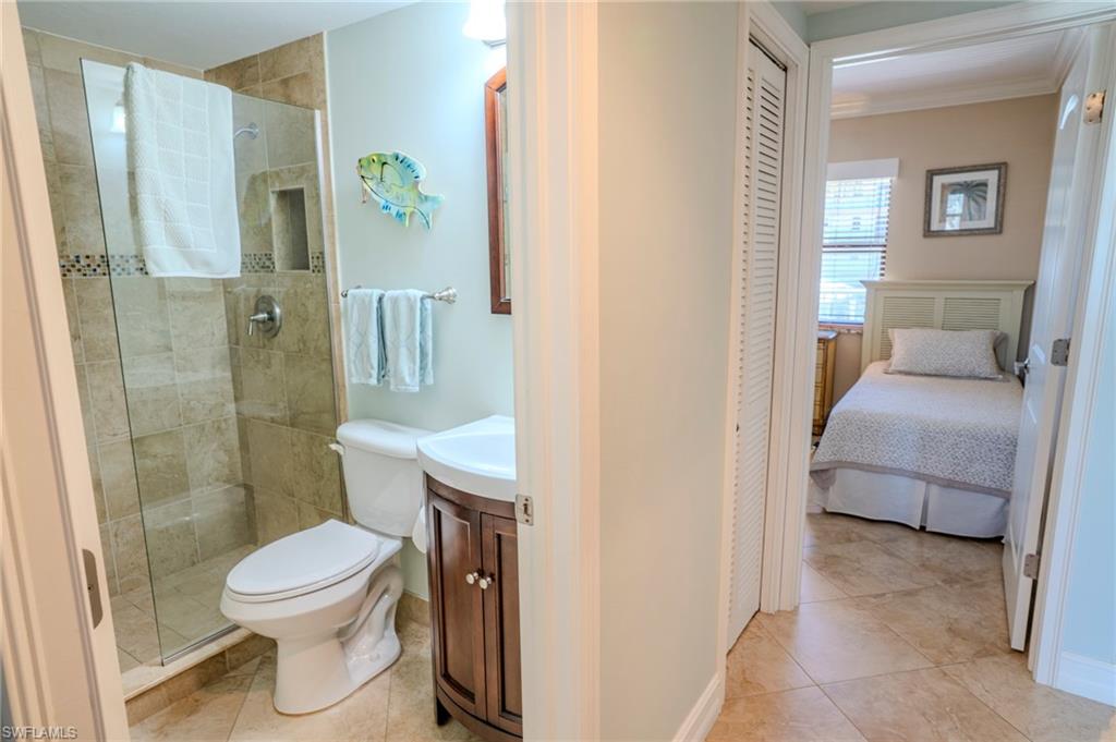 803 River Point Drive, Unit 105B Naples, FL 34102 - Photo 28 of 36 a bathroom with a toilet a sink and shower