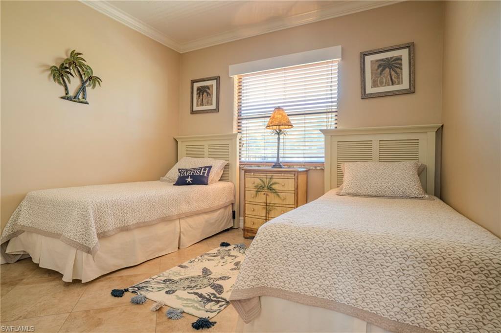 803 River Point Drive, Unit 105B Naples, FL 34102 - Photo 30 of 36 a bedroom with a bed and a window