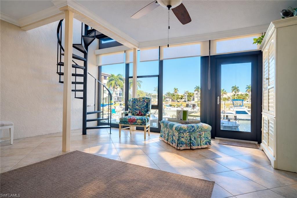 803 River Point Drive, Unit 105B Naples, FL 34102 - Photo 3 of 36 a living room with furniture and a large window