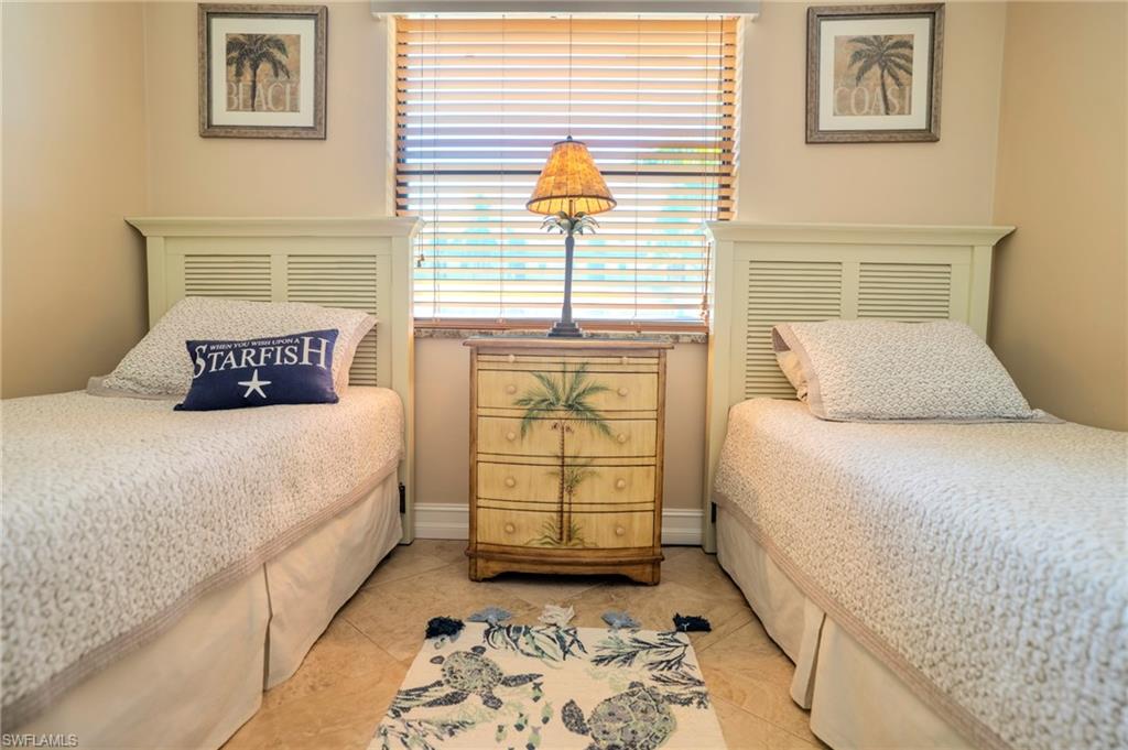 803 River Point Drive, Unit 105B Naples, FL 34102 - Photo 32 of 36 a bedroom with a bed and a window