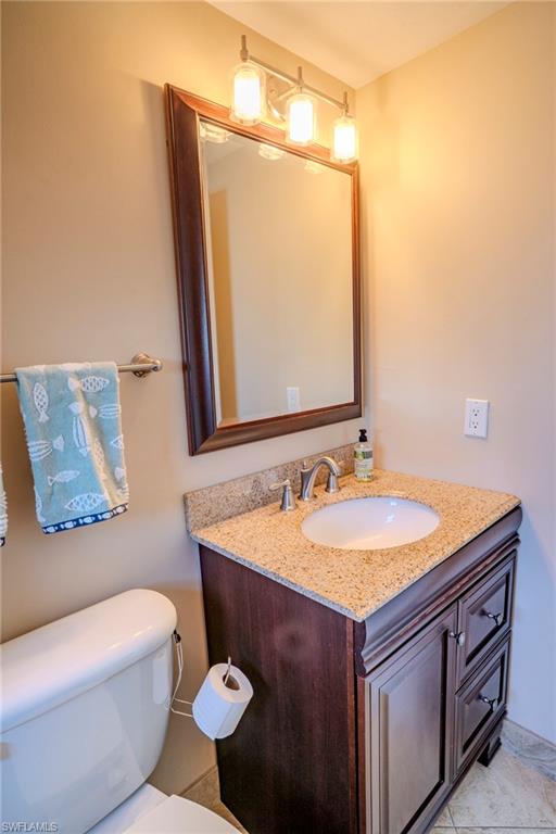 803 River Point Drive, Unit 105B Naples, FL 34102 - Photo 33 of 36 a bathroom with a sink and a mirror