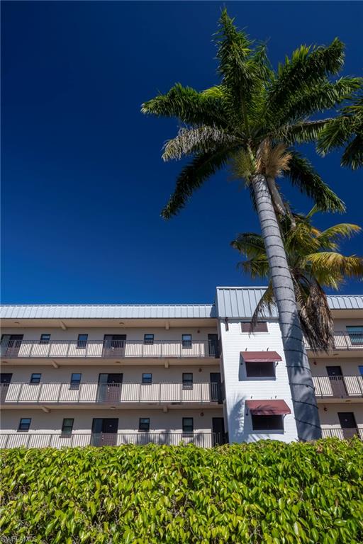803 River Point Drive, Unit 105B Naples, FL 34102 - Photo 36 of 36 a view of a building with a garden