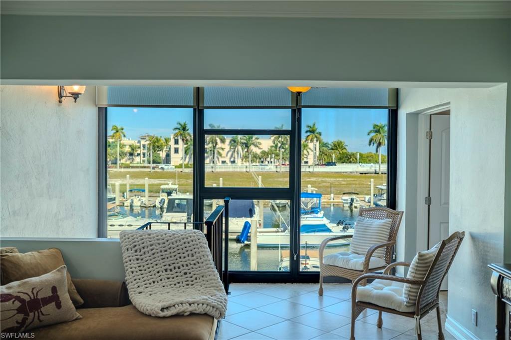 803 River Point Drive, Unit 105B Naples, FL 34102 - Photo 4 of 36 a living room with furniture and a large window