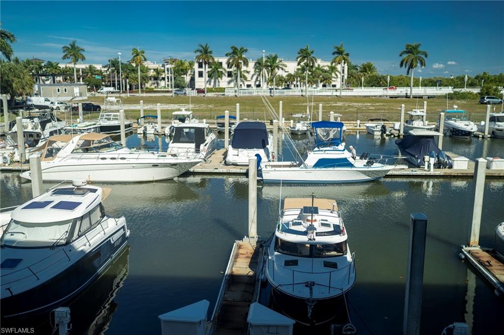 803 River Point Drive, Unit 105B Naples, FL 34102 - Photo 5 of 36 a table and chairs sitting in the middle of a lake