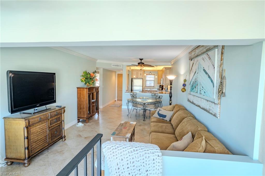 803 River Point Drive, Unit 105B Naples, FL 34102 - Photo 10 of 36 a living room with furniture and a flat screen tv