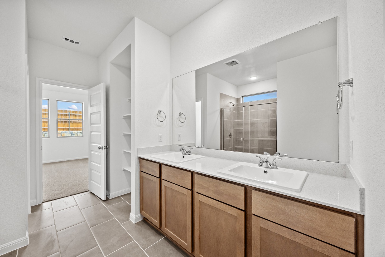 200 Hornet Street Elgin, TX 78621 - Photo 17 of 39 a bathroom with a double vanity sink mirror and