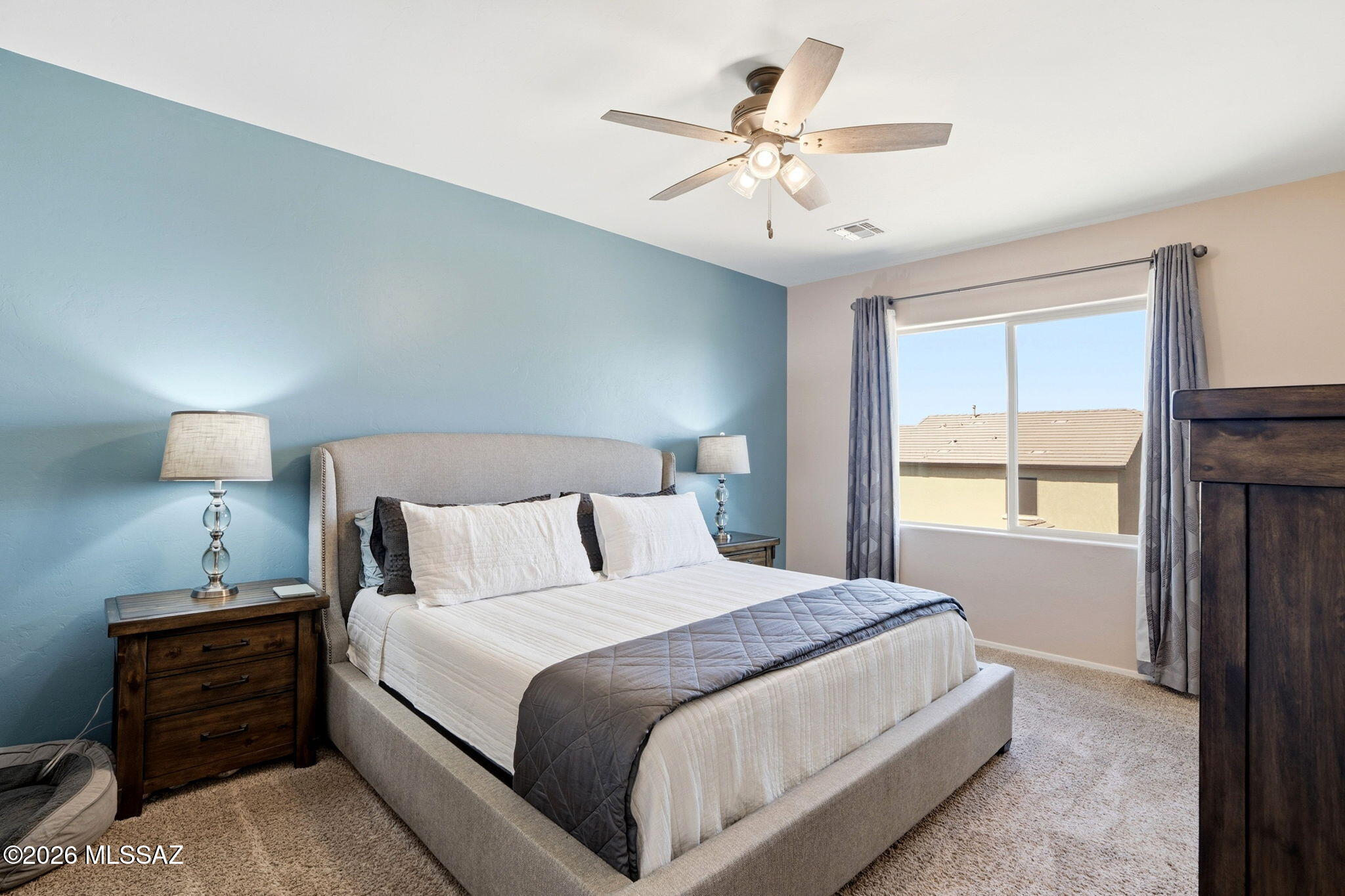 211 East Refuge Loop Vail, AZ 85641 - Photo 16 of 48 a bedroom with a large bed and a chandelier