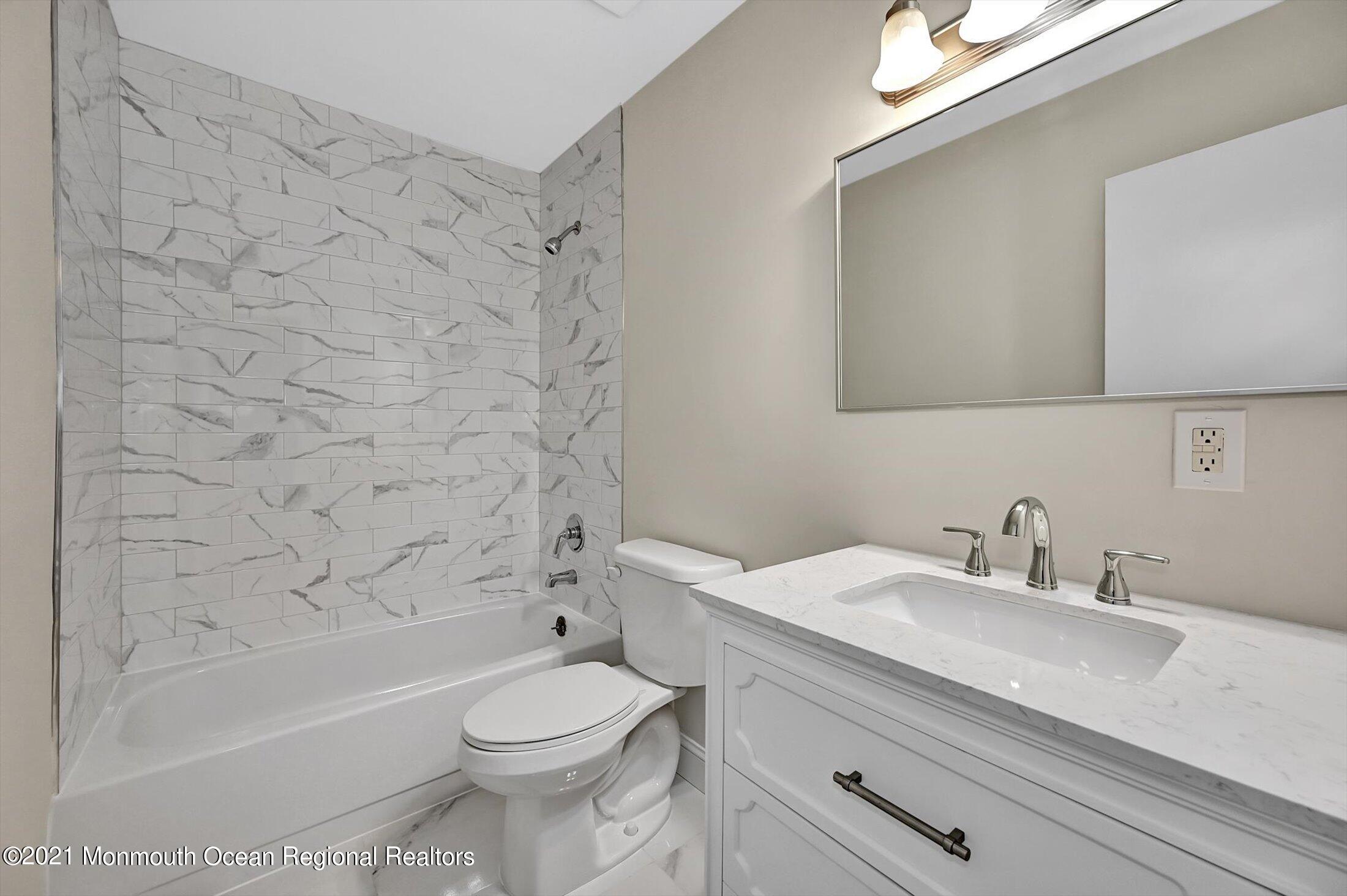 7 Creek Road Brick, NJ 08724 - Photo 12 of 14 a bathroom with a sink a toilet and a bathtub