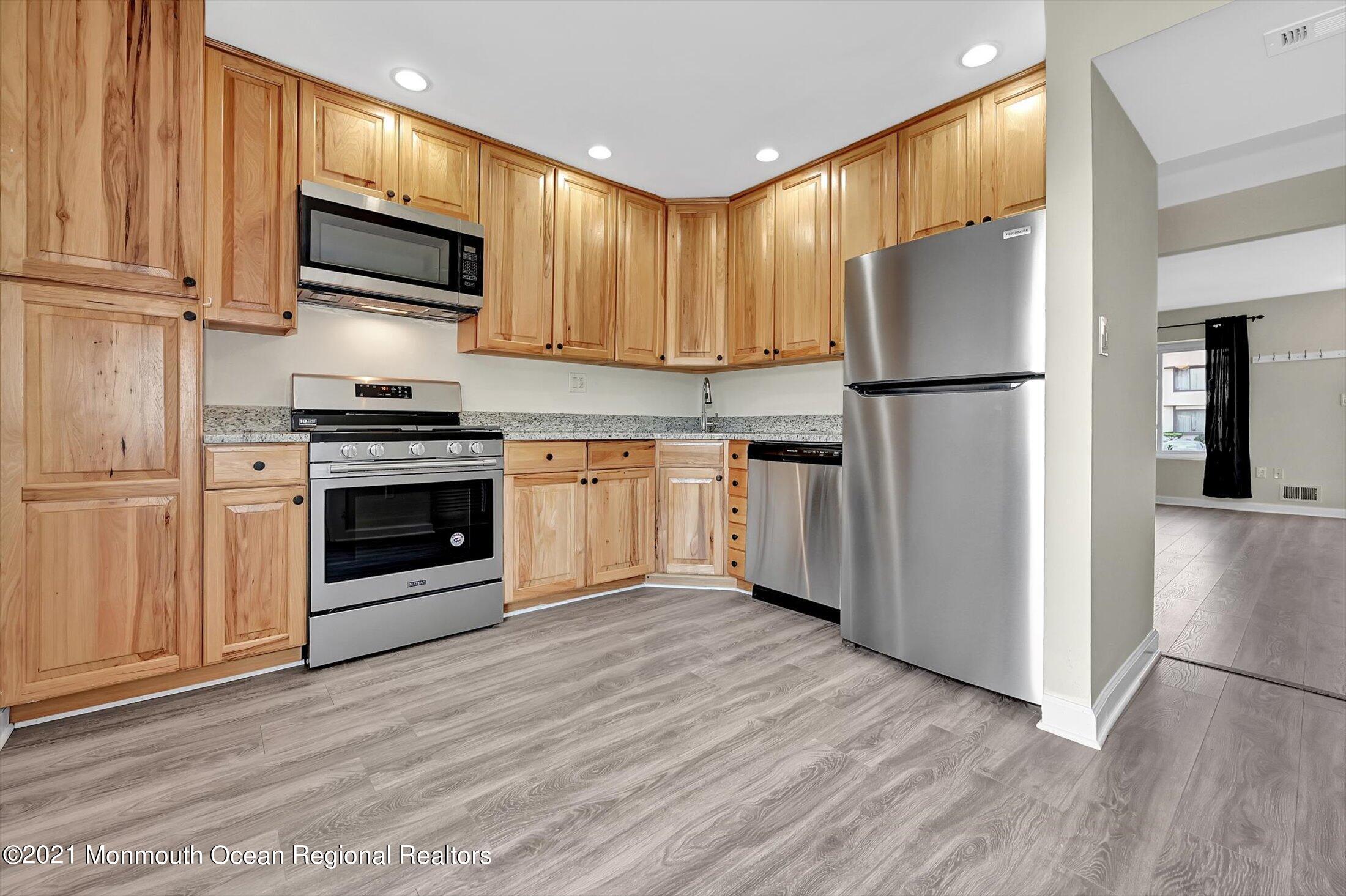 7 Creek Road Brick, NJ 08724 - Photo 6 of 14 a kitchen with stainless steel appliances granite countertop a refrigerator stove a sink and a microwave