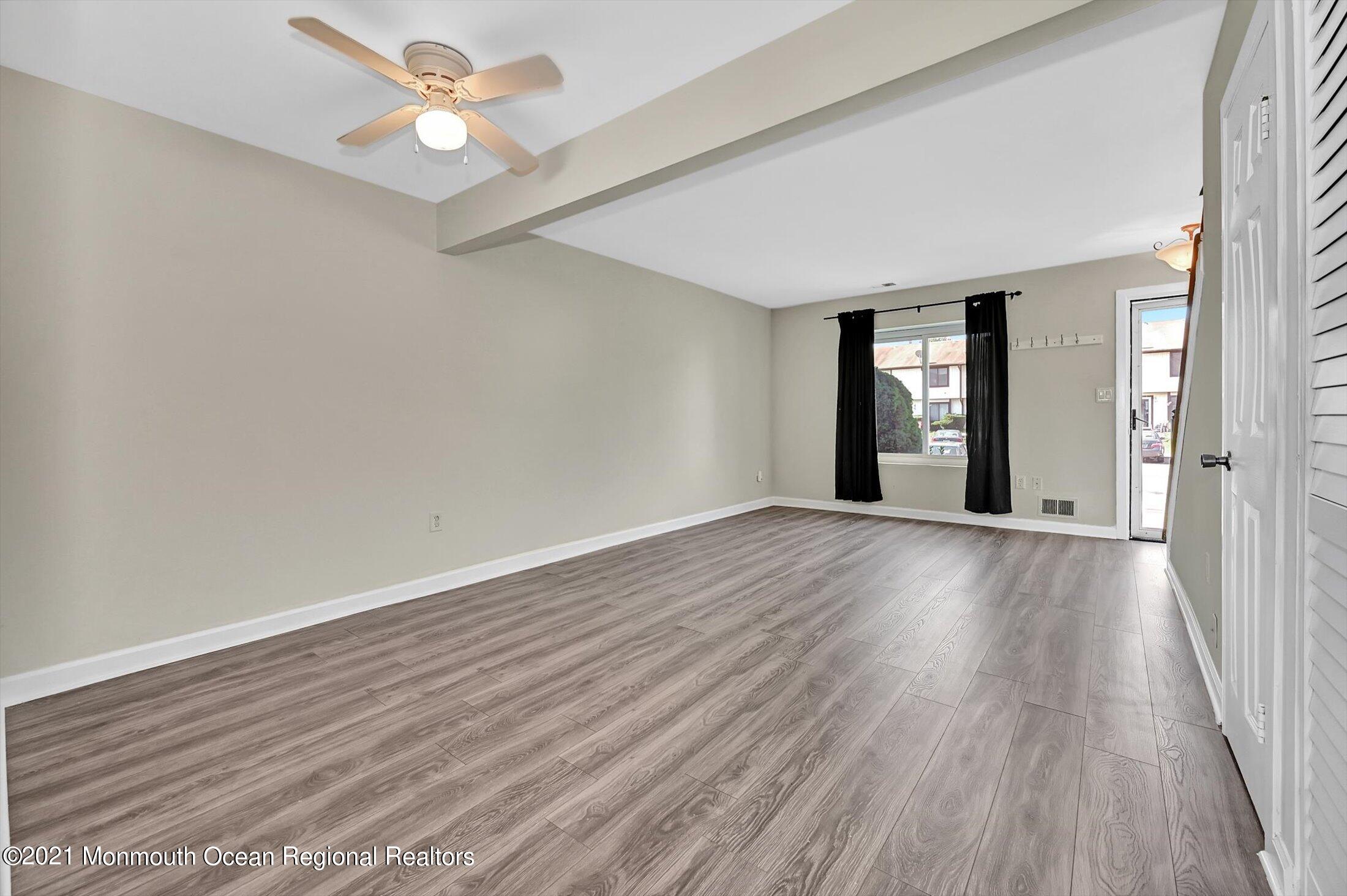 7 Creek Road Brick, NJ 08724 - Photo 8 of 14 wooden floor in an empty room with a window
