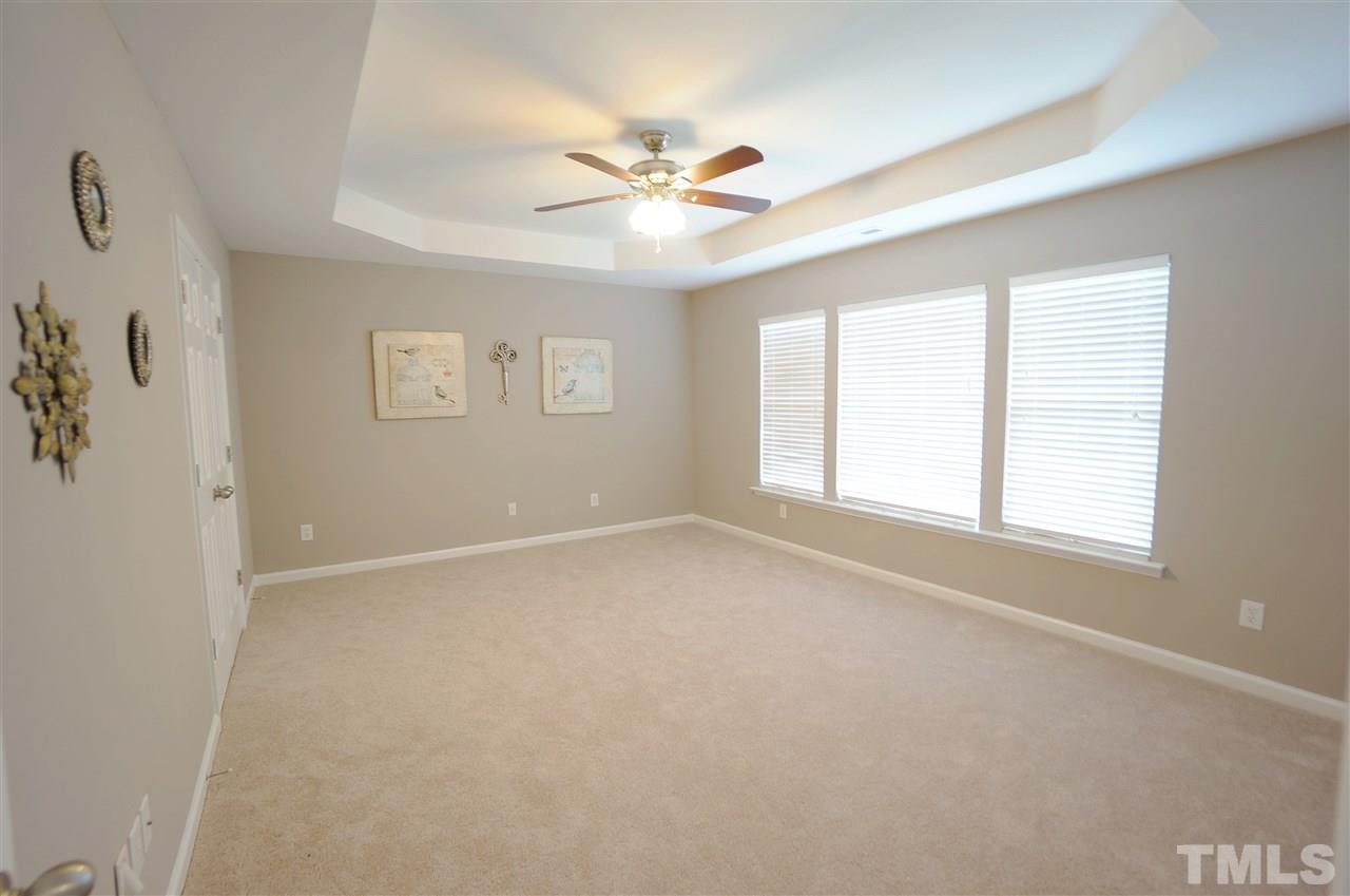 7730 San Gabriel Street Raleigh, NC 27613 - Photo 14 of 25 Master Suite has a spacious layout to accommodate furniture layouts. The trey ceiling lends to the spacious & open feel. Windows overlook the tree lined lot.