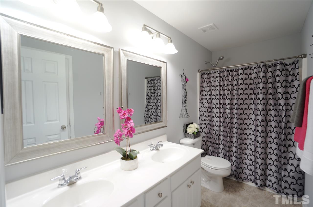 7730 San Gabriel Street Raleigh, NC 27613 - Photo 19 of 25 Hall bath has dual vanities, style & charm.