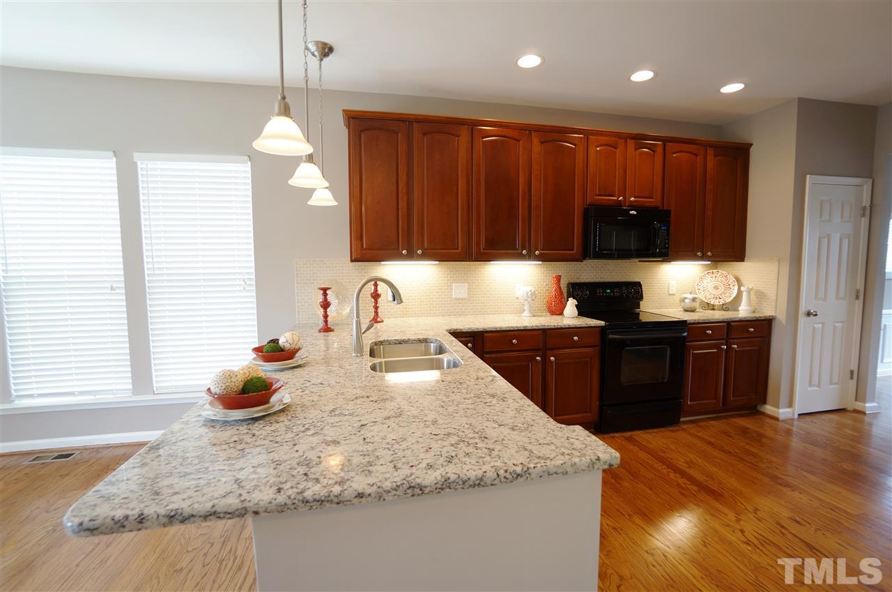 7730 San Gabriel Street Raleigh, NC 27613 - Photo 8 of 25 Rich textures & clean design make this kitchen very welcoming & inviting.