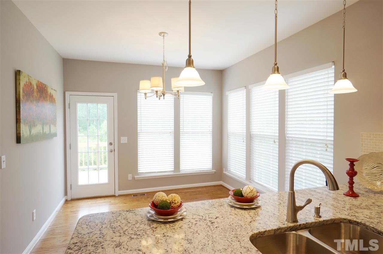 7730 San Gabriel Street Raleigh, NC 27613 - Photo 9 of 25 Breakfast area is bright, charming & has a lovely view of the tree lined lot.