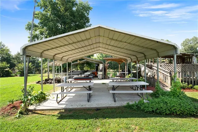 a view of a park with large trees and a pathway