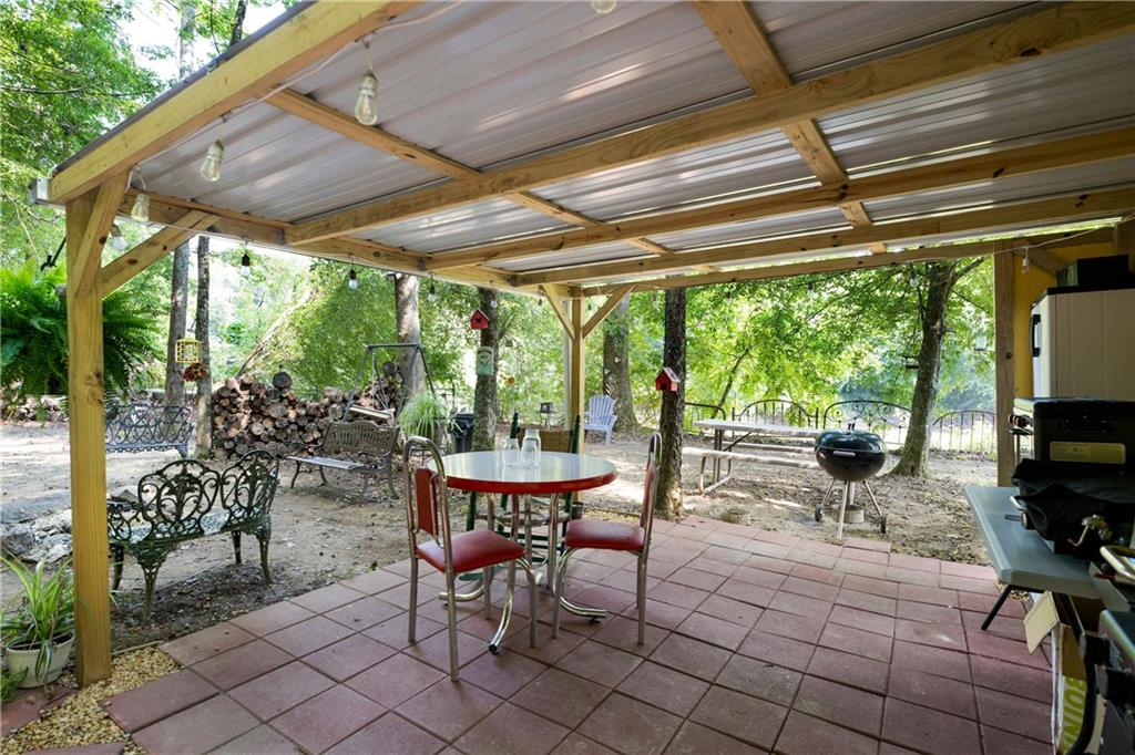 669 Nicklesville Road Northeast Resaca, GA 30735 - Photo 29 of 60 a outdoor space with chairs a couch and swing