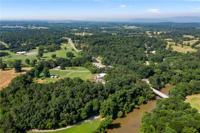 an aerial view of residential building with outdoor space and trees