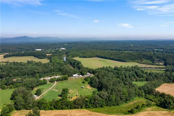 an aerial view of lake and residential houses with outdoor space