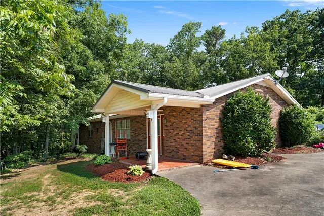 a front view of a house with yard patio and swimming pool