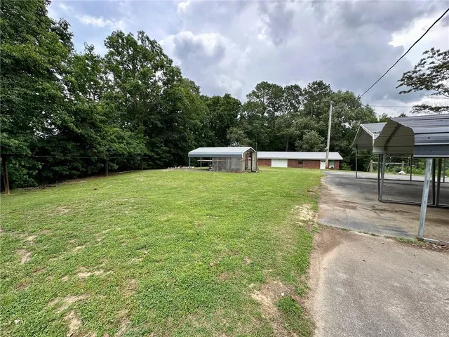 a view of a livingroom with furniture and a window