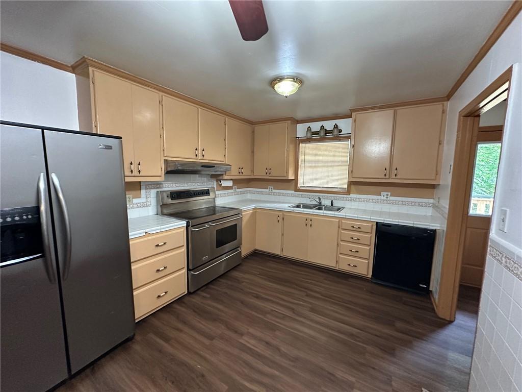 669 Nicklesville Road Northeast Resaca, GA 30735 - Photo 47 of 60 a kitchen with stainless steel appliances granite countertop a refrigerator a sink dishwasher a stove with wooden floors and cabinets