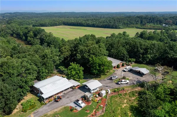 a view of a swimming pool with lawn chairs under an umbrella