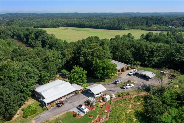 a view of a swimming pool with lawn chairs under an umbrella