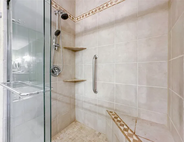 a bathroom with a glass shower door