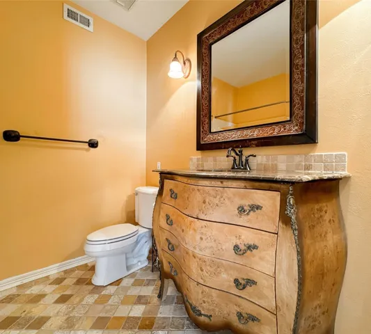 a bathroom with a sink toilet and mirror