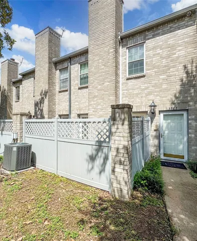 a view of a brick house with many windows