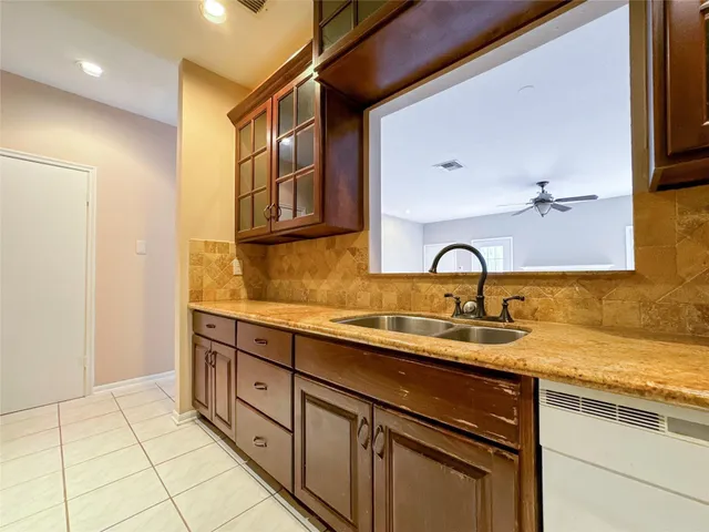 a kitchen with sink and cabinets