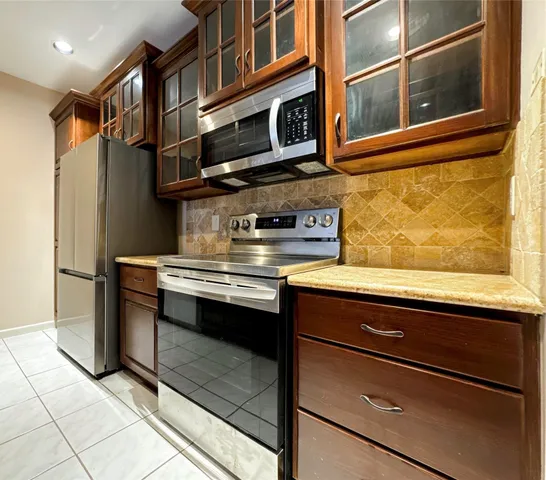 a kitchen with stainless steel appliances granite countertop a stove and a microwave